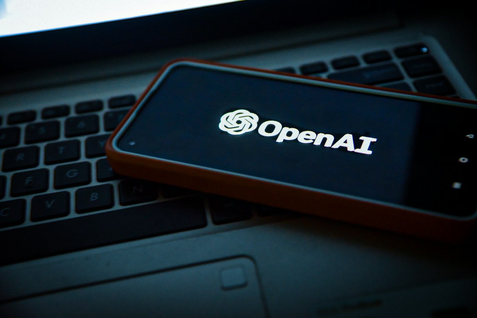 a cell phone sitting on top of a laptop computer; GPT-6 Sol and Luna