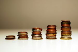 Stacks of coins increasing in height from left to right; enterprise cost reduction strategies