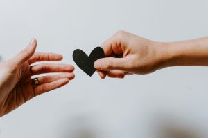 hand giving heart to other hand - partnership equity