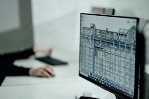person at desk viewing monitor; prop firm platform architecture