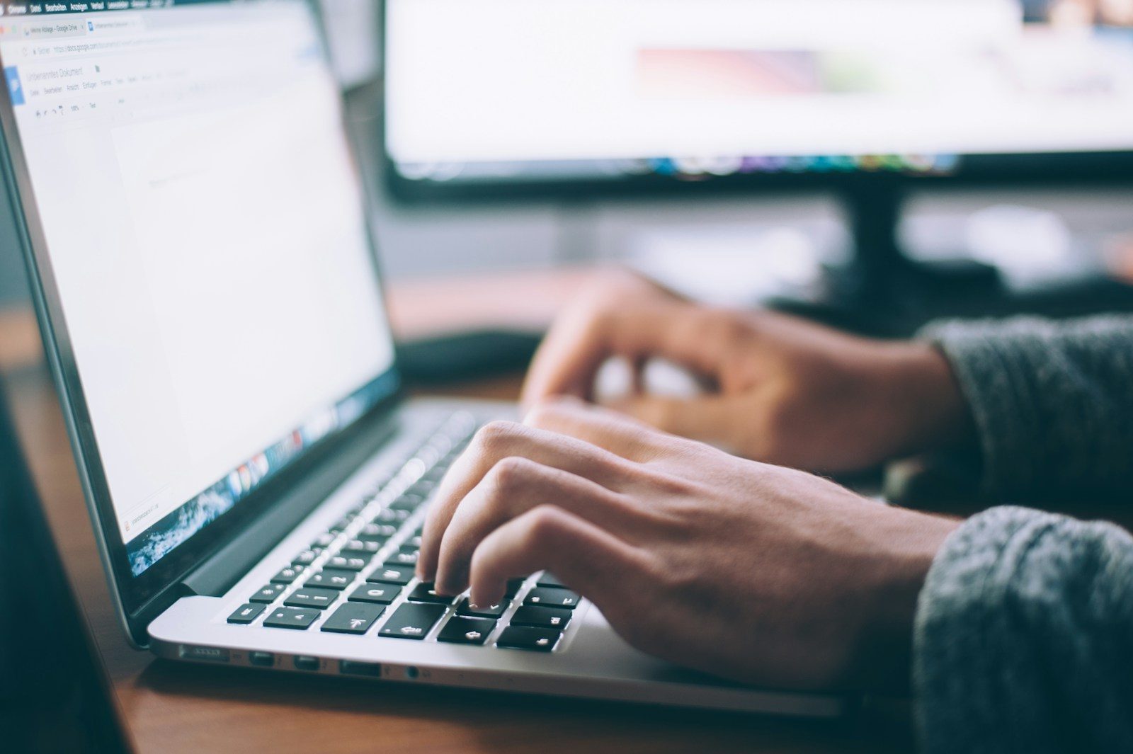 person using MacBook Pro; domain name