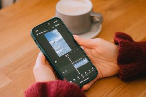 Someone is editing a video on their phone; text to video AI