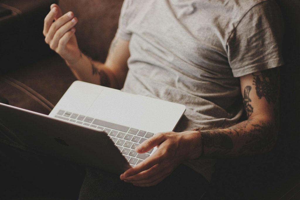 person white laptop computer; PolyBuzz AI