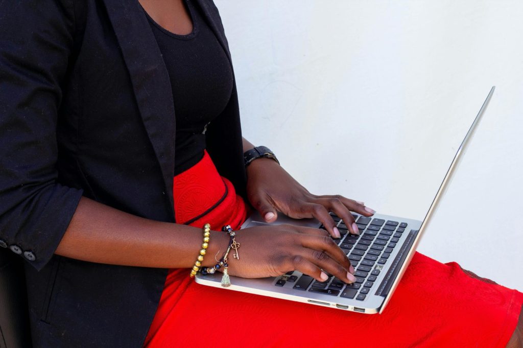 woman with laptop on her lap maximing productivity with tech tools